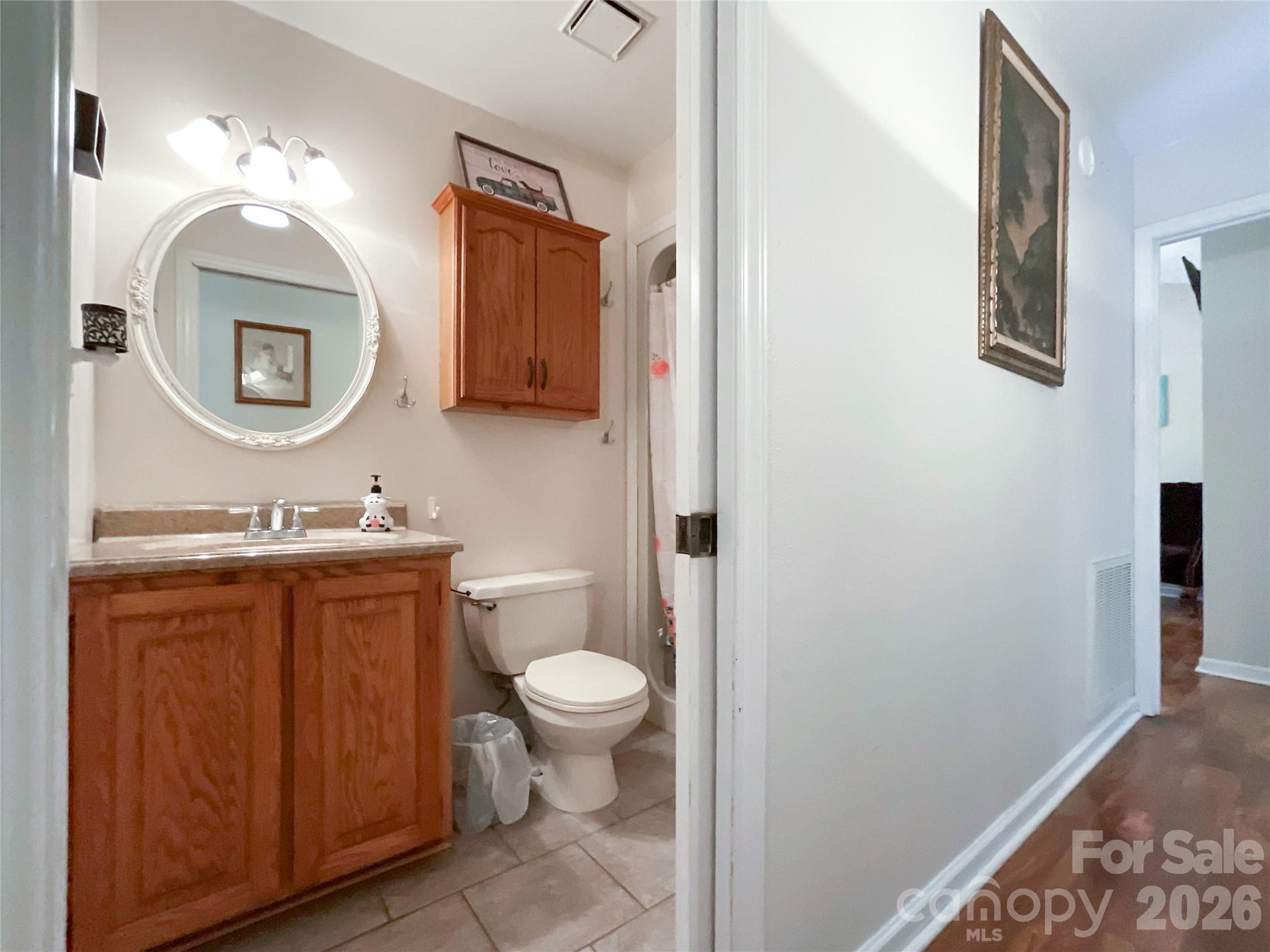 7200 Nesbit Road Waxhaw, NC 28173 - Photo 20 of 46 a bathroom with a toilet a sink a mirror and a window