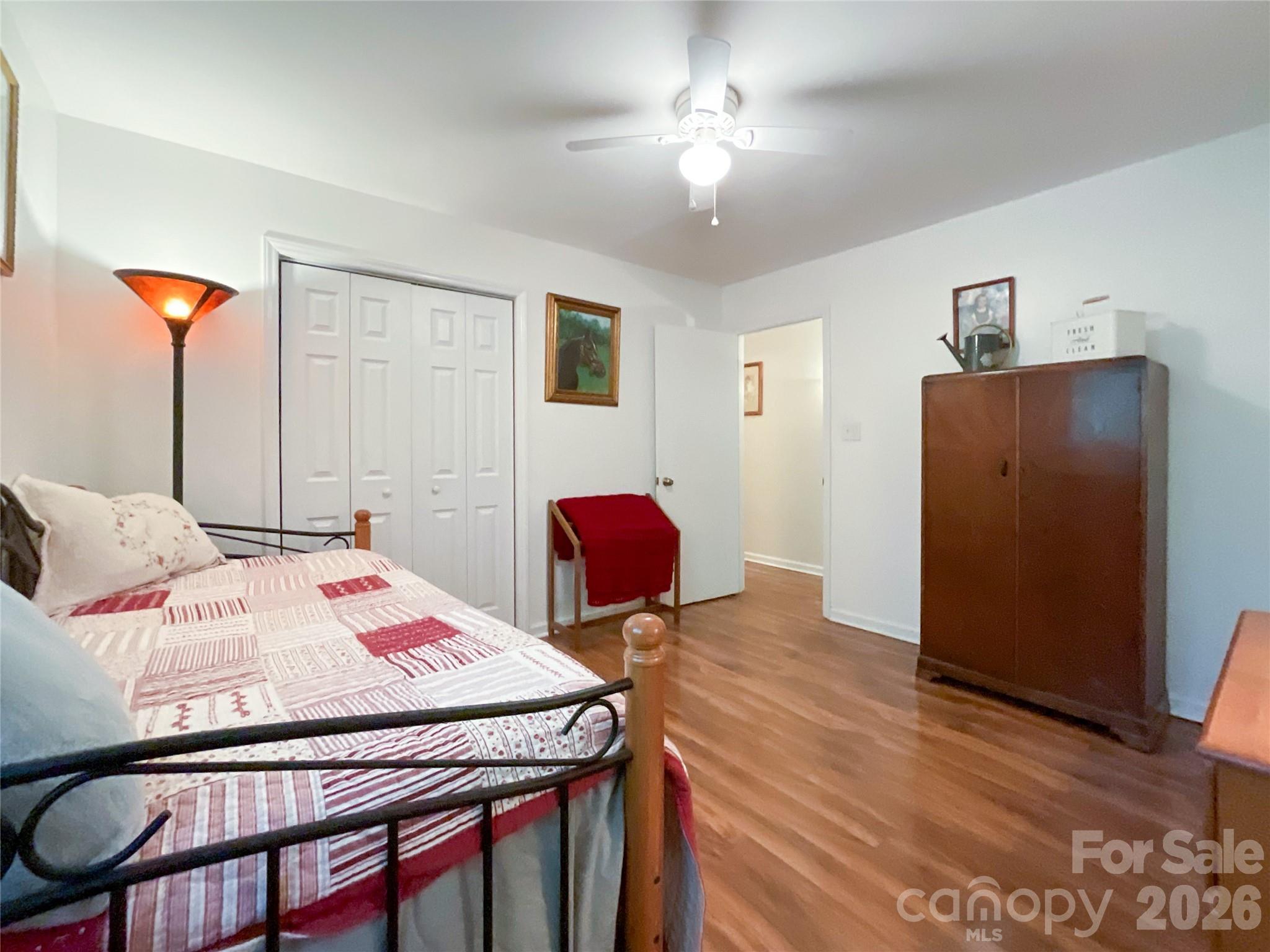 7200 Nesbit Road Waxhaw, NC 28173 - Photo 21 of 46 a bedroom with a bed and chandelier