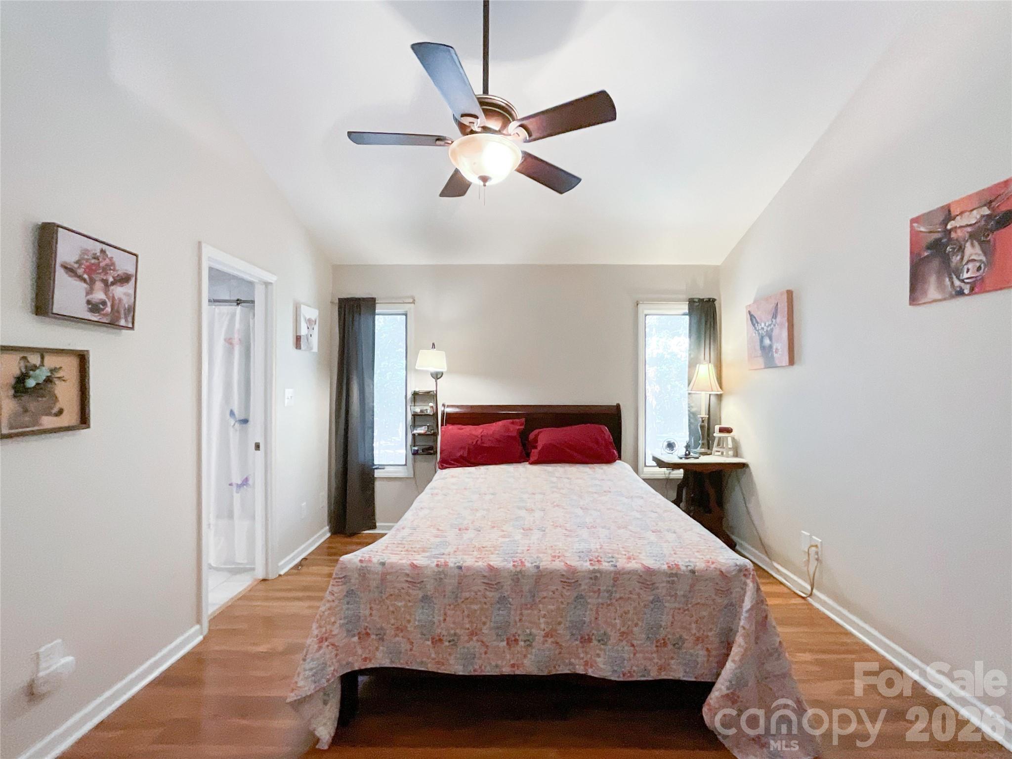 7200 Nesbit Road Waxhaw, NC 28173 - Photo 29 of 46 a bedroom with a bed and a chandelier