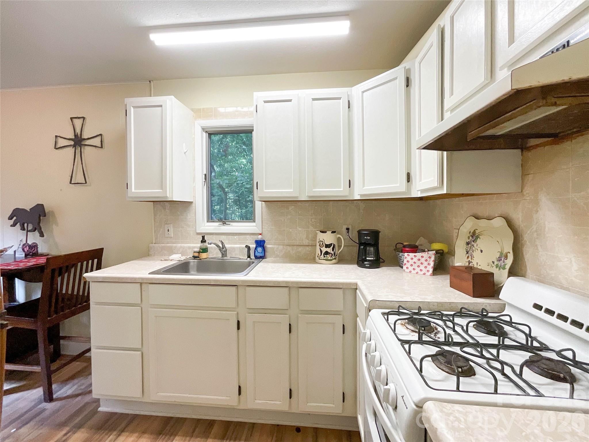 7200 Nesbit Road Waxhaw, NC 28173 - Photo 39 of 46 a kitchen with a sink stove and cabinets