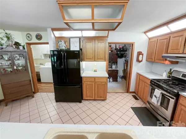 a kitchen with a dining table chairs and appliances