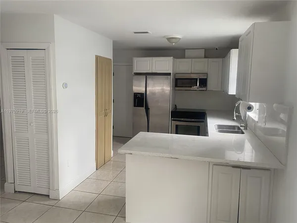 a kitchen with stainless steel appliances a sink a stove and a refrigerator