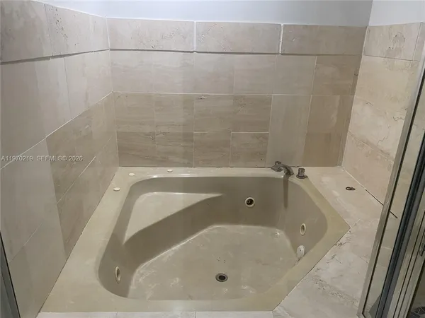 a bathroom with a glass door shower