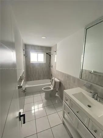 an empty room with staircase and a ceiling fan