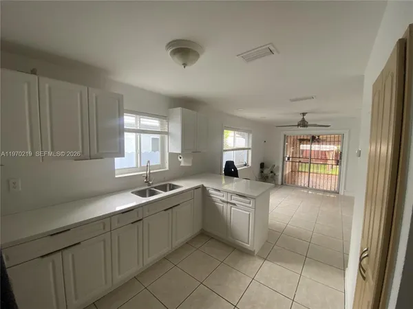 a kitchen with a sink and cabinets