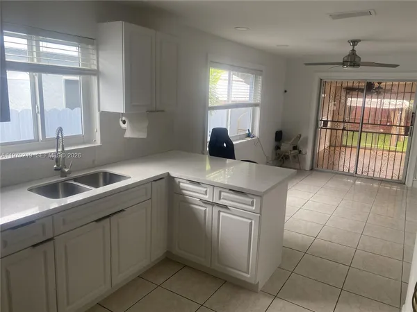 a kitchen with stainless steel appliances a refrigerator sink and cabinets