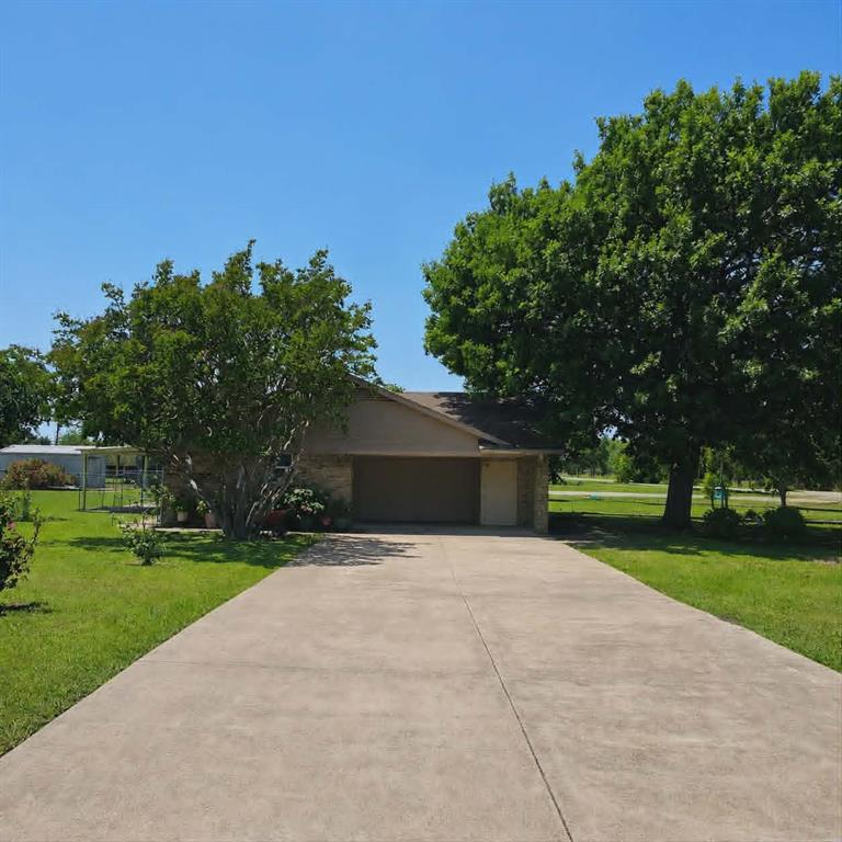 14752 Ranch Road Forney, TX 75126 - Photo 35 of 40 Ranch-style exterior with a two-car garage, concrete driveway, and mature landscaping
