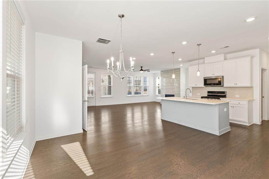 4734 Dewitt Drive Duluth, GA 30097 - Photo 17 of 31 a view of kitchen with kitchen island stainless steel appliances refrigerator stove microwave and cabinets