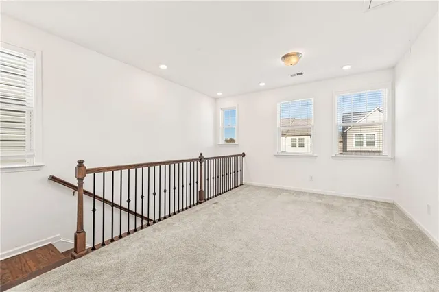 a view of an empty room with windows