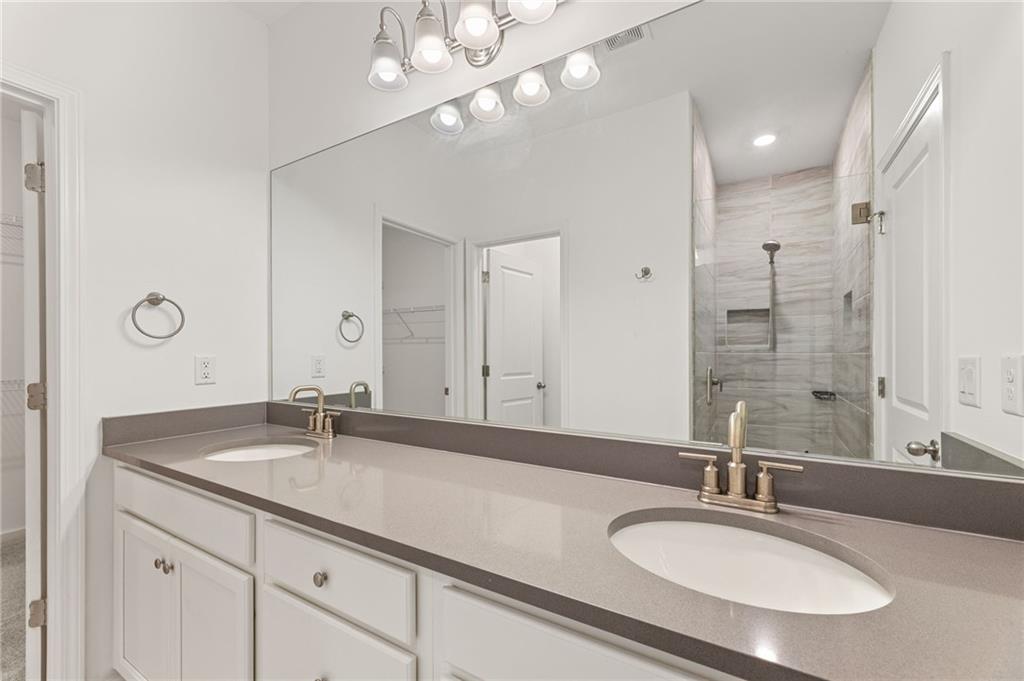4734 Dewitt Drive Duluth, GA 30097 - Photo 24 of 31 a bathroom with a sink double vanity and a mirror