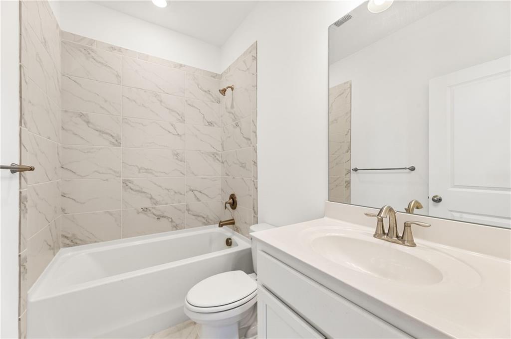 4734 Dewitt Drive Duluth, GA 30097 - Photo 28 of 31 a bathroom with a sink toilet and shower