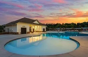a view of a house with swimming pool and a chairs