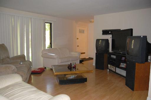 1303 Yarmouth Court, Unit 1303 Schaumburg, IL 60193 - Photo 2 of 11 a living room with furniture and a window
