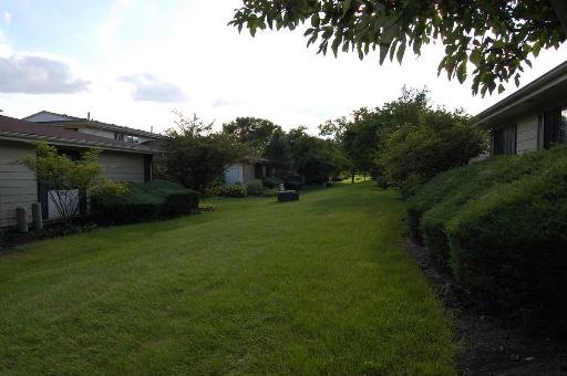 1303 Yarmouth Court, Unit 1303 Schaumburg, IL 60193 - Photo 11 of 11 a view of a backyard with plants and a garden
