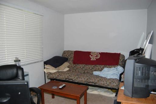 1303 Yarmouth Court, Unit 1303 Schaumburg, IL 60193 - Photo 7 of 11 a living room with furniture and a flat screen tv