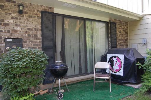 1303 Yarmouth Court, Unit 1303 Schaumburg, IL 60193 - Photo 10 of 11 a front view of a house with backyard and chairs