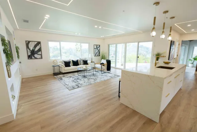 a living room with patio furniture and a fireplace