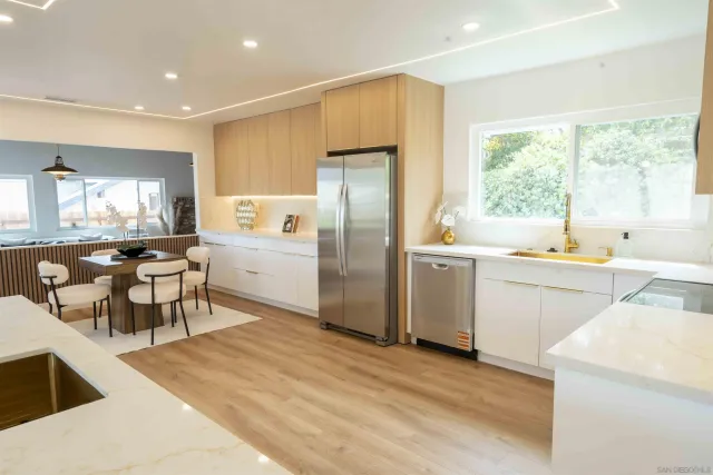 a view of a hallway with wooden floor and entryway