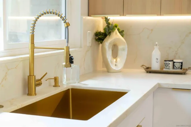 an empty room with wooden floor chandelier fan and windows