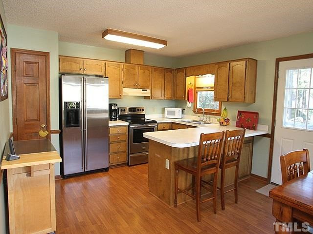 Kitchen with plenty of counter space and bar area. Kitchen