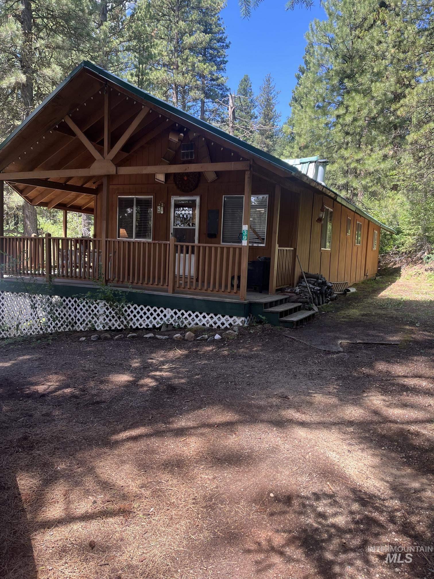 39 Mayflower Mine Road Placerville, ID 83666 - Photo 2 of 36 Covered front porch with wooden railings and lattice skirting