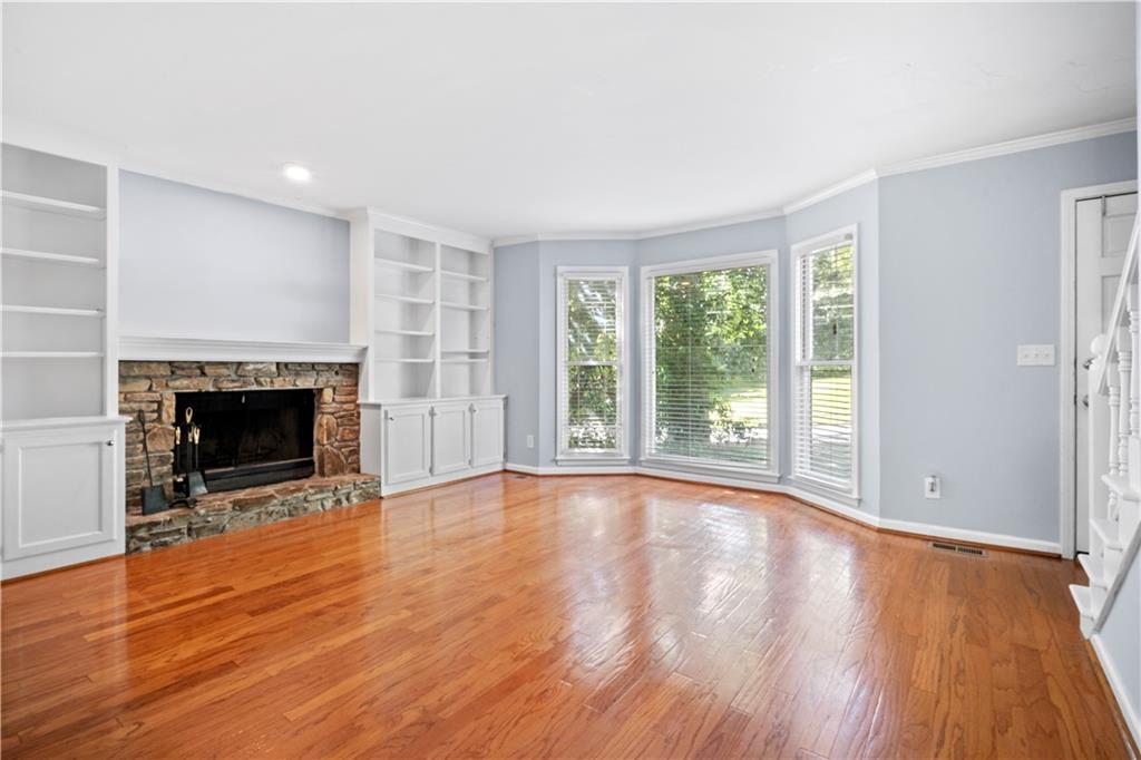 661 North Parkwood Road, Unit C Decatur, GA 30030 - Photo 5 of 14 a view of an empty room with wooden floor and a window
