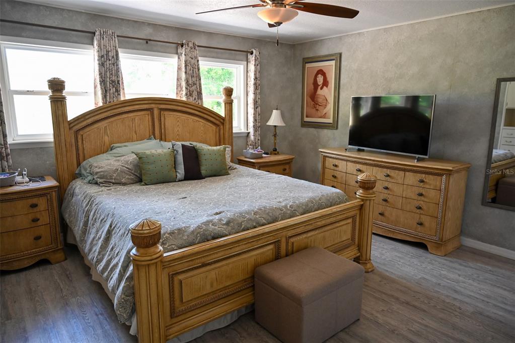 4501 Detour Road Haines City, FL 33844 - Photo 20 of 65 a bedroom with a bed and a flat tv screen on dresser