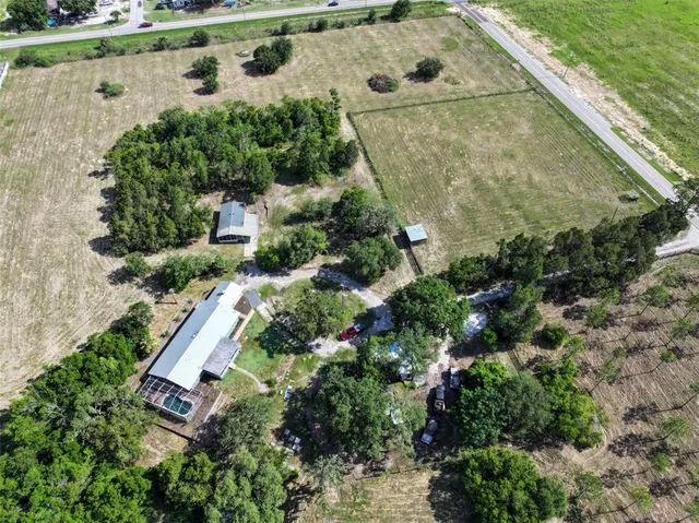 an aerial view of a house with a yard