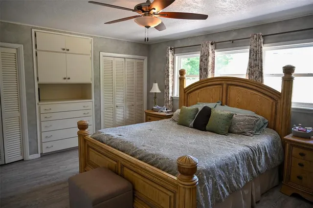 a bedroom with furniture and a flat screen tv