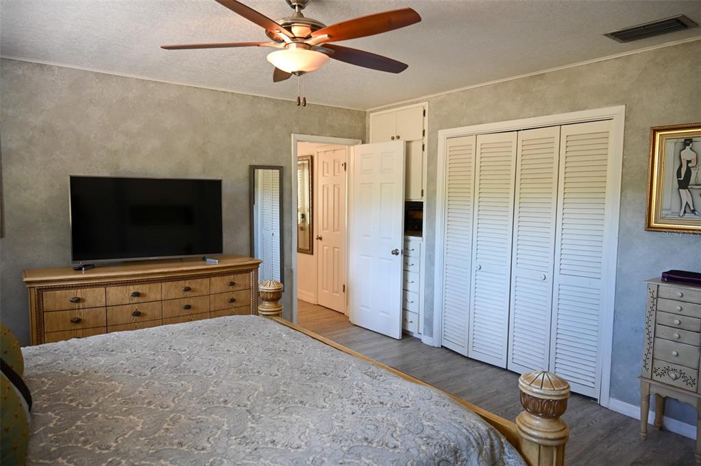 4501 Detour Road Haines City, FL 33844 - Photo 22 of 65 a bedroom with furniture and a flat screen tv