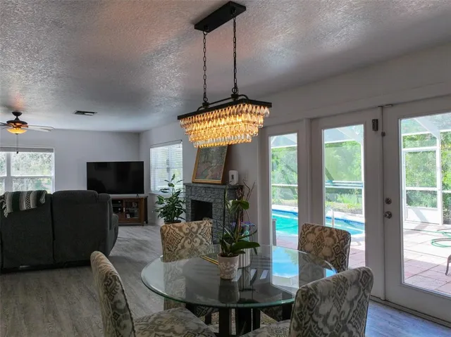 a living room with furniture large window and a fireplace