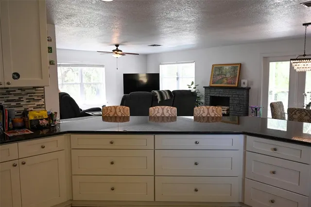 a kitchen with cabinets a window and stainless steel appliances