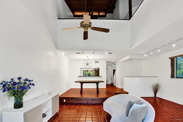 a living room with furniture and flowers