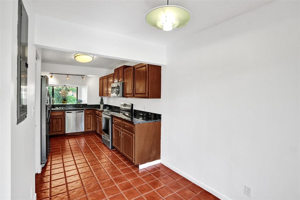 81 Northeast 17th Court Fort Lauderdale, FL 33305 - Photo 11 of 70 a kitchen with stainless steel appliances granite countertop a stove a sink and a refrigerator