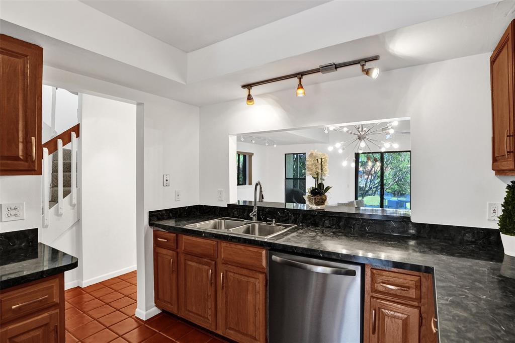 81 Northeast 17th Court Fort Lauderdale, FL 33305 - Photo 14 of 70 a kitchen with a sink and a refrigerator