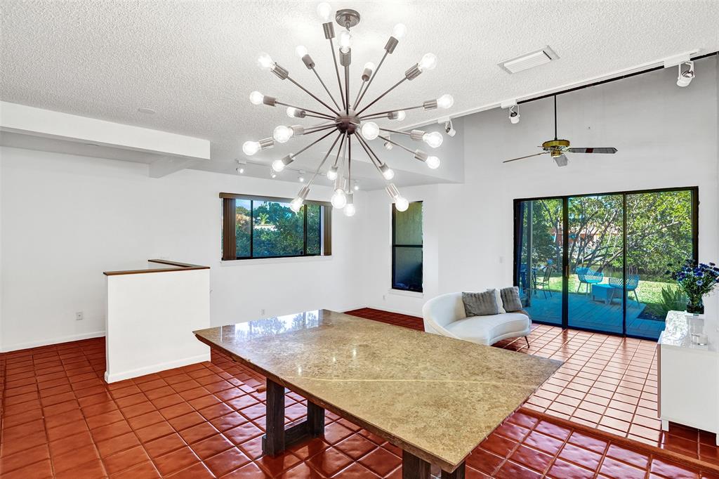 81 Northeast 17th Court Fort Lauderdale, FL 33305 - Photo 19 of 70 a view of a dining room with furniture and a floor to ceiling window