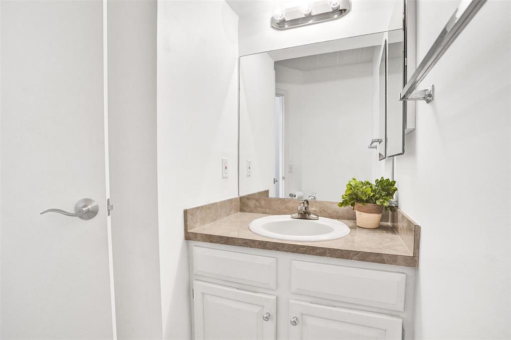 81 Northeast 17th Court Fort Lauderdale, FL 33305 - Photo 25 of 70 a bathroom with a sink and a mirror