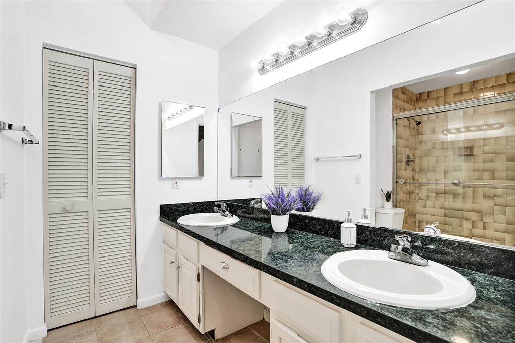 81 Northeast 17th Court Fort Lauderdale, FL 33305 - Photo 33 of 70 a bathroom with a granite countertop sink and a mirror