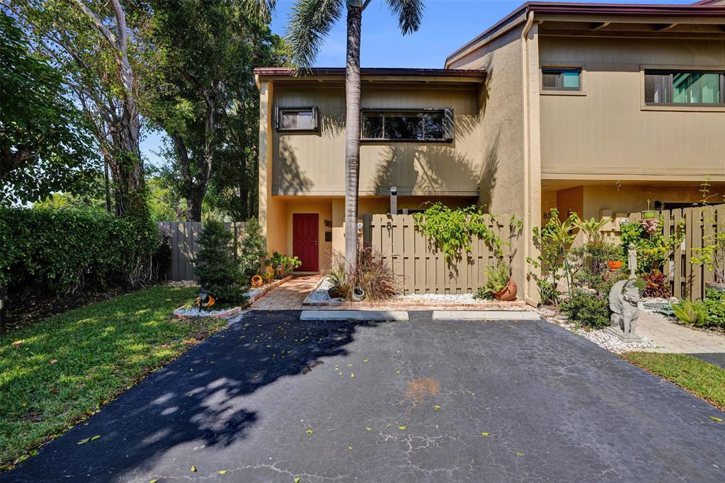 81 Northeast 17th Court Fort Lauderdale, FL 33305 - Photo 4 of 70 a front view of a house with a yard and garage