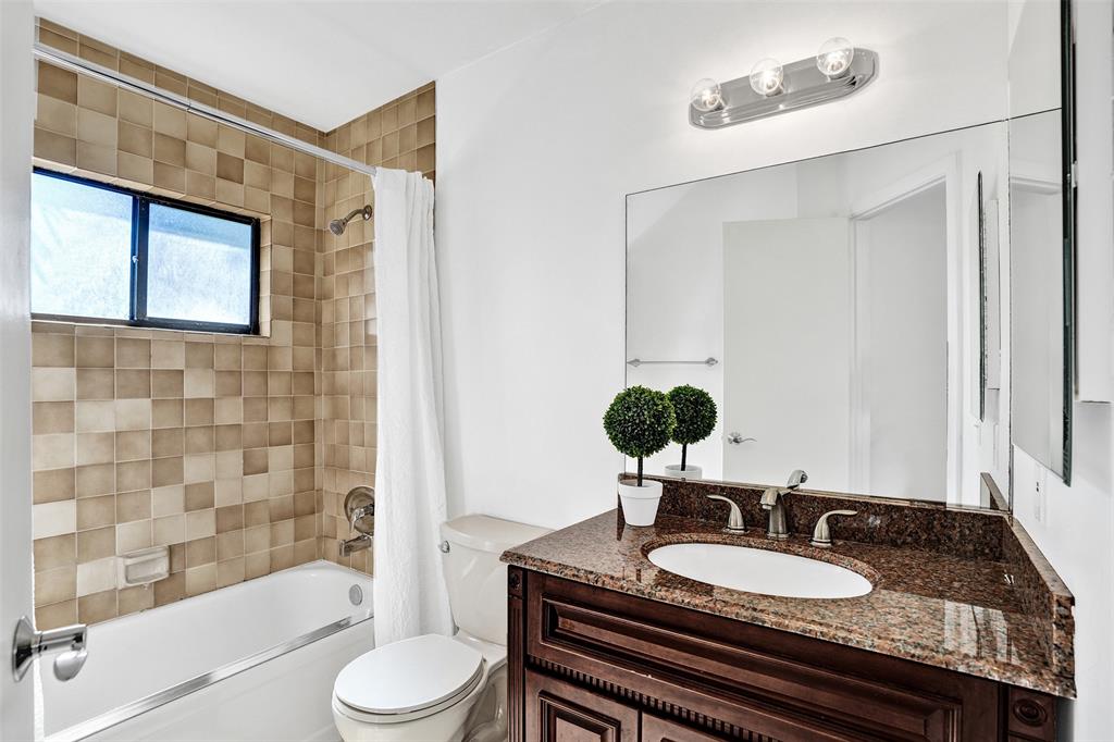81 Northeast 17th Court Fort Lauderdale, FL 33305 - Photo 47 of 70 a bathroom with a granite countertop sink toilet a mirror and shower