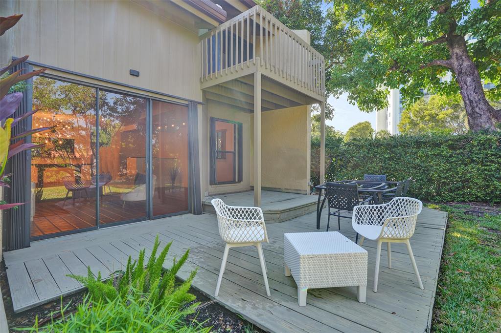81 Northeast 17th Court Fort Lauderdale, FL 33305 - Photo 53 of 70 a patio with table and chairs and potted plants