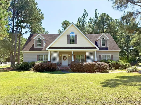 a front view of house with yard and trees around