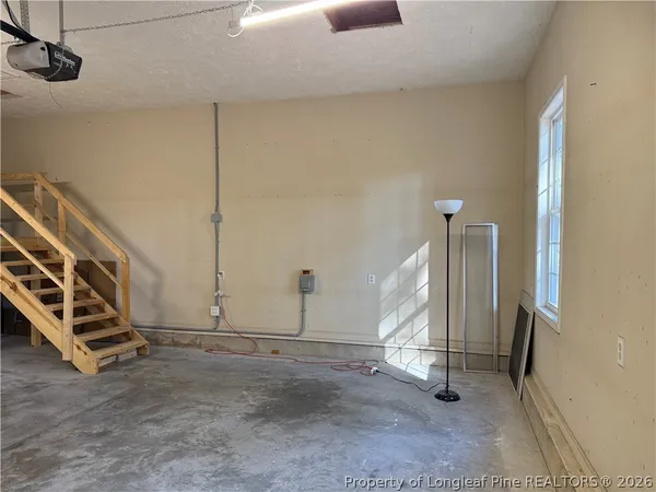 a view of a room with wooden floor and windows
