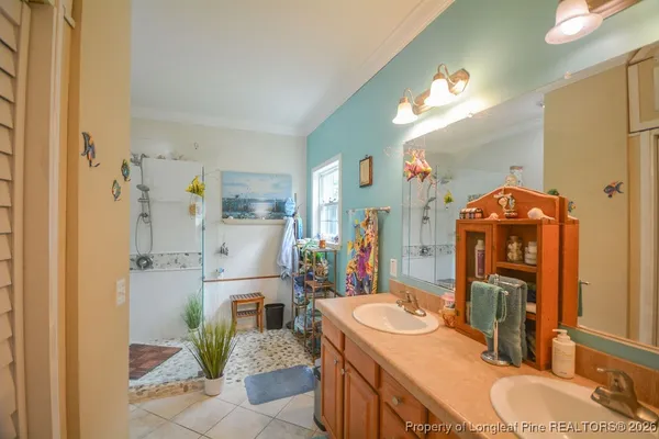 a bathroom with a granite countertop sink a toilet a mirror and shower