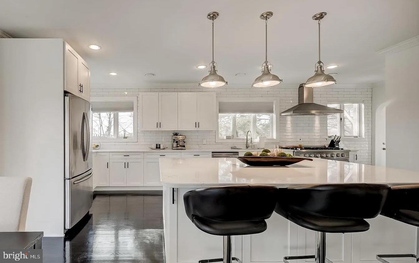 8040 Leishear Road Laurel, MD 20723 - Photo 11 of 66 a kitchen with stainless steel appliances granite countertop a refrigerator a sink dishwasher a stove and white cabinets with wooden floor