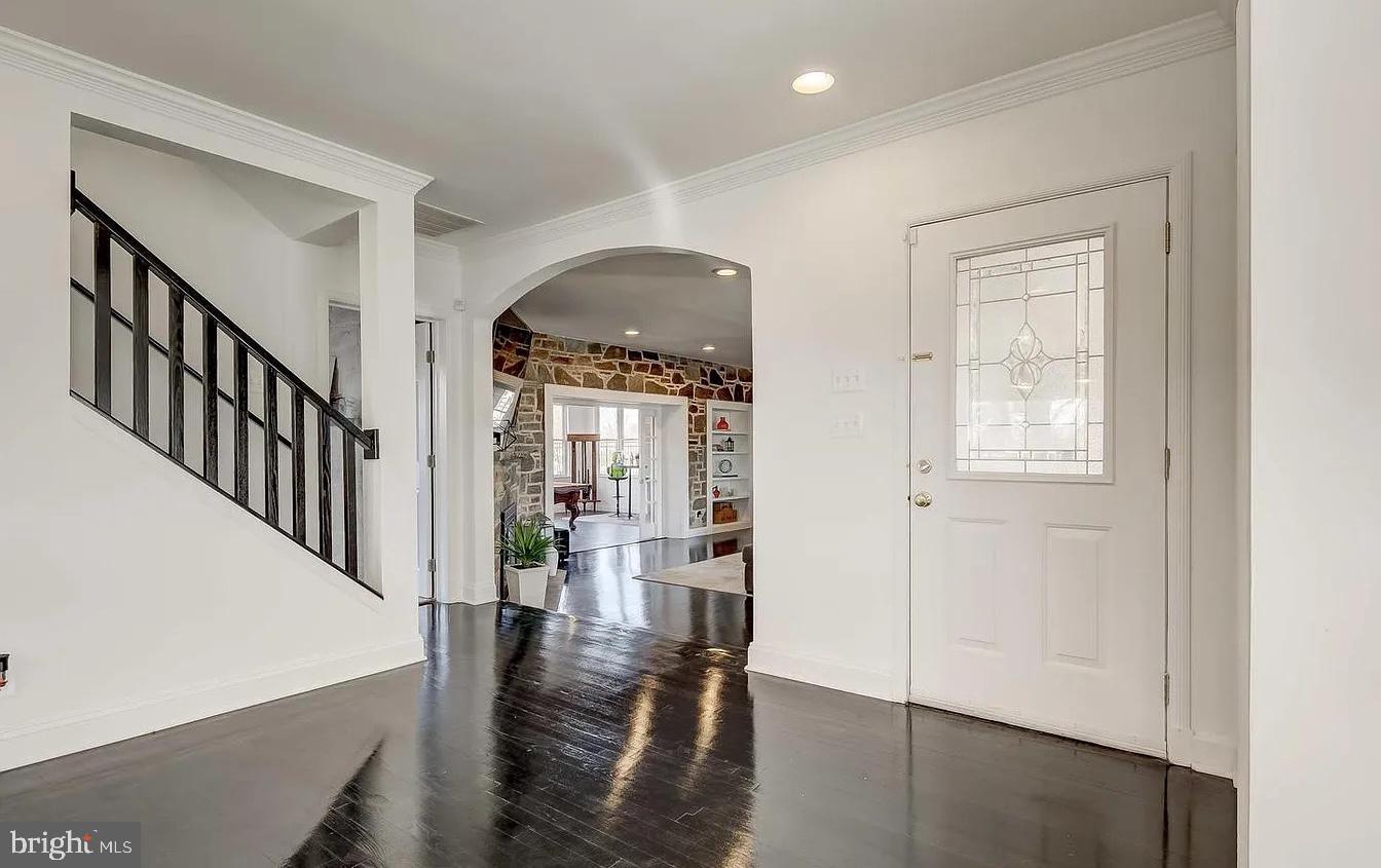 8040 Leishear Road Laurel, MD 20723 - Photo 14 of 66 a hallway with wooden floor windows and stairs