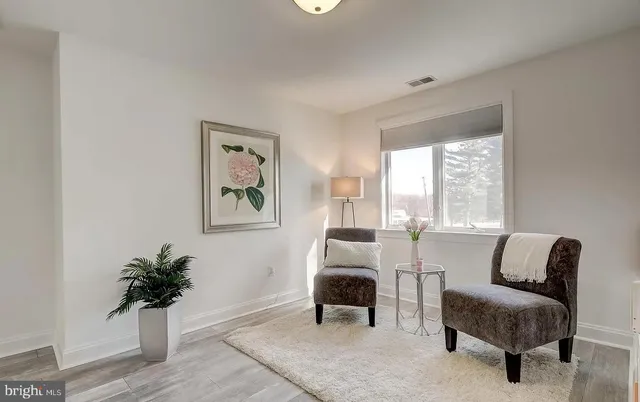 a room with pool table and windows