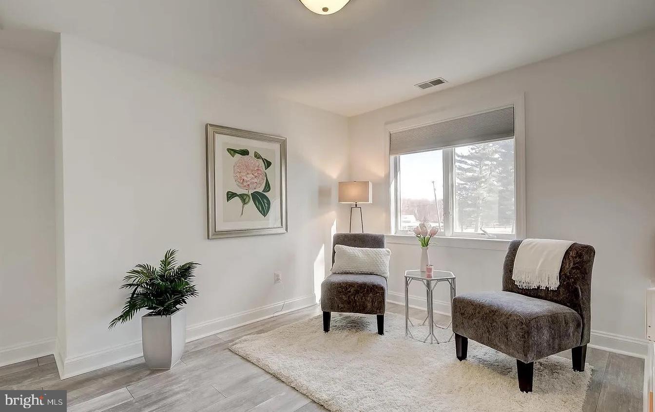 8040 Leishear Road Laurel, MD 20723 - Photo 23 of 66 a living room with furniture and a potted plant