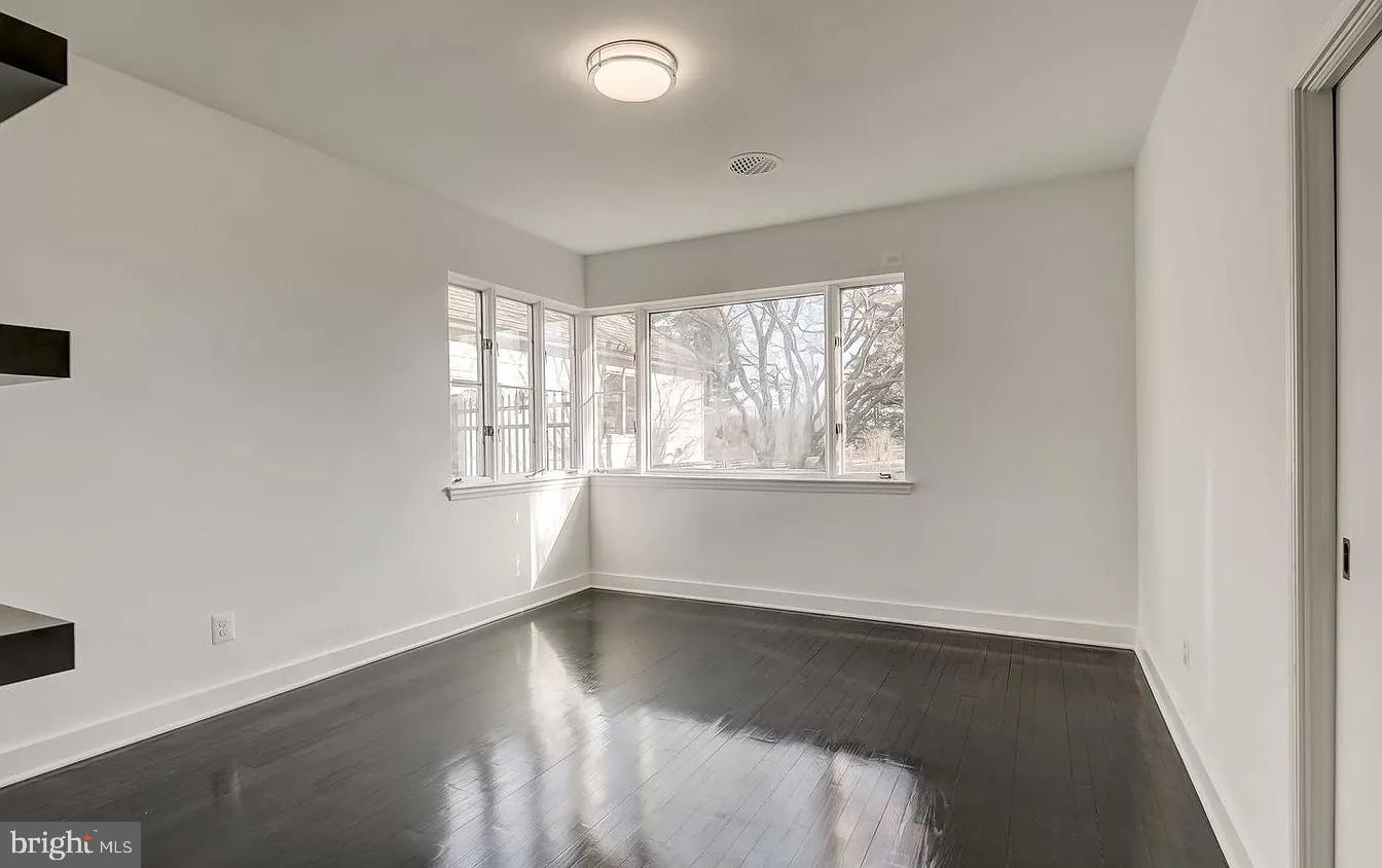 8040 Leishear Road Laurel, MD 20723 - Photo 27 of 66 an empty room with wooden floor and windows