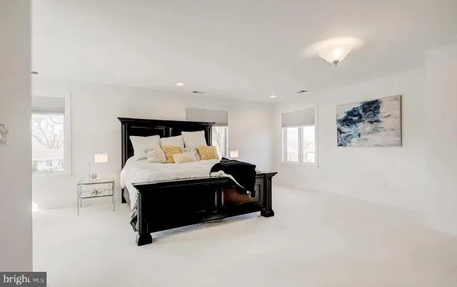 a kitchen with stainless steel appliances kitchen island granite countertop a table and chairs in it